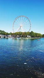 Ferris wheel against clear blue sky