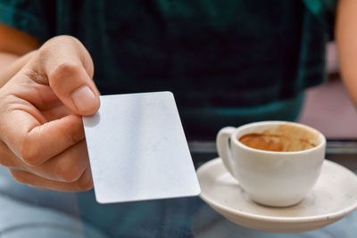 Midsection of coffee cup on table