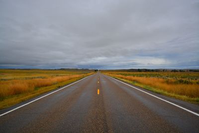 Road on field against sky