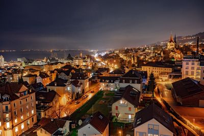 High angle view of illuminated city against sky at night