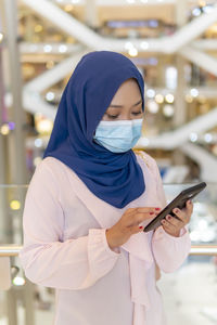 Midsection of woman using mobile phone