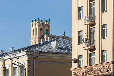 Low angle view of buildings against blue sky