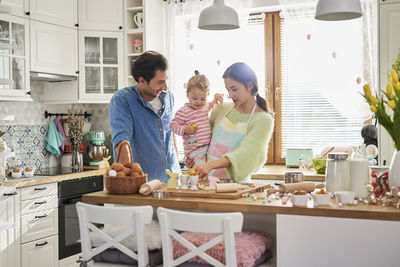 Family preparing food in kitchen