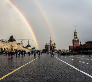 View of rainbow over buildings in city