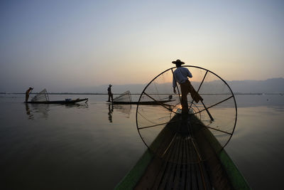 Boat in sea at sunset