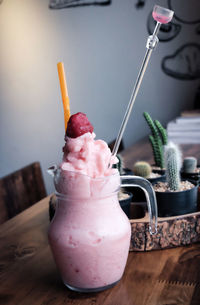 Strawberry smoothie on wooden table