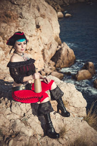 Portrait of a pirate woman at the beach. in anticipation of a pirate ship