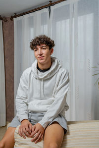 Portrait of young man sitting at home