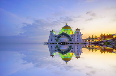 View of majestic mosque against cloudy sky