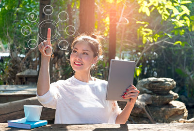 Portrait of young woman using mobile phone