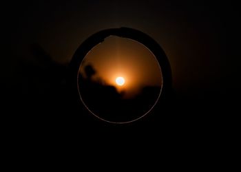 Close-up of illuminated light at sunset