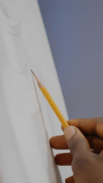 Close-up of hand holding pencils