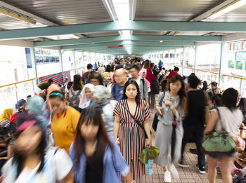 Standing woman in multi ethnic crowded city hong kong