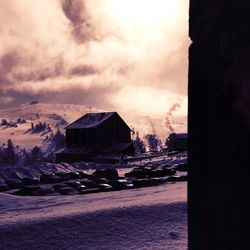 Scenic view of snow covered mountains against cloudy sky