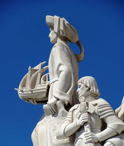 Low angle view of statue against blue sky