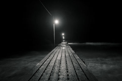 View of illuminated beach lights at night