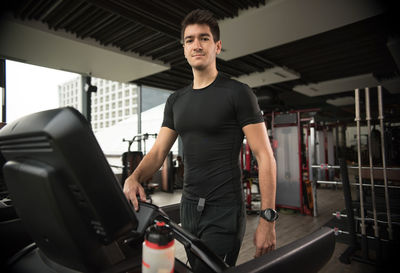 Full length of young man sitting at home