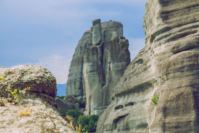 Low angle view of rock formation against sky