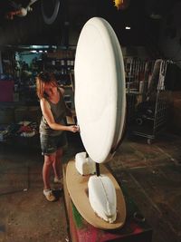 Young woman working in his artistic workshop.