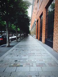 Footpath amidst street in city