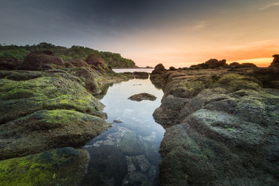 Scenic view of rock formation against sky during sunset