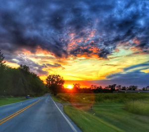 Road against dramatic sky during sunset