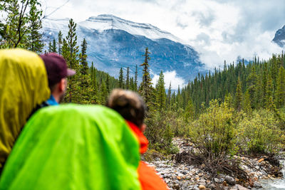 Couple observing fresh snow on nearby mountain peak during hike