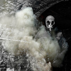Man wearing gas mask in tunnel