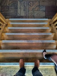 Low section of woman standing on stairs