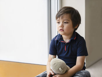 Cute boy sitting at home