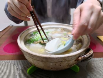 Close-up of hand holding bowl