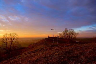 Scenic view of field against sky at sunset