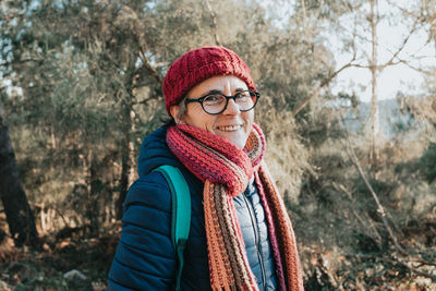 Portrait of young woman standing in forest