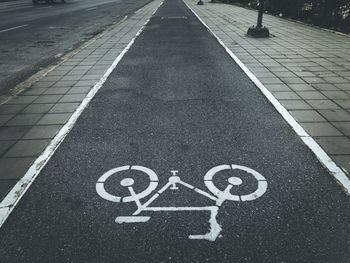 High angle view of arrow sign on road