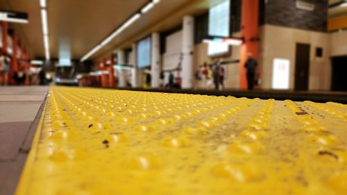 Close-up of yellow paint on railroad station