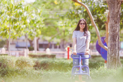 Full length of woman on grass against trees