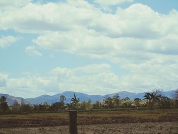 Scenic view of landscape against cloudy sky