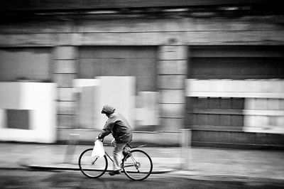 Man riding bicycle on road