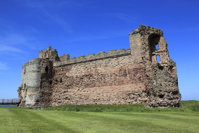 Low angle view of old building against blue sky