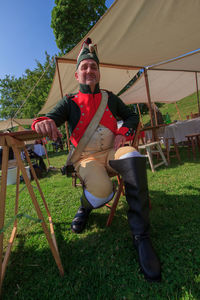 Full length of man sitting on field