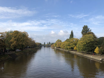 Arch bridge over river against sky