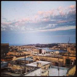 Buildings against cloudy sky