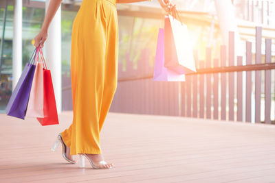 Midsection of woman holding umbrella