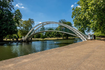 Arch bridge over river against sky