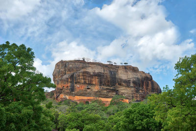 Low angle view of rock formations against sky