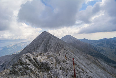 Scenic view of mountains against cloudy sky