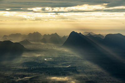 Scenic view of mountains against sky at sunset