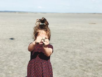 Full length of woman standing on beach