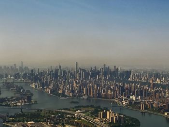 High angle view of river by buildings in city against sky