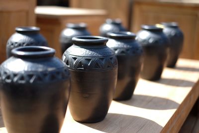 Decorative urns on wooden table for sale